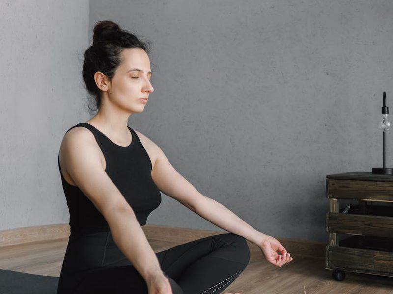 Person practicing a calm yoga flow in a minimalist room.